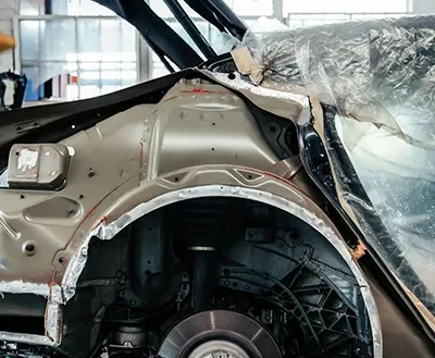Structural repair in progress on a vehicle frame at Avio Coach Craft